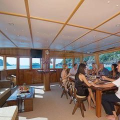 Luxury Sailing & Motor Catamaran dining for eight in the saloon